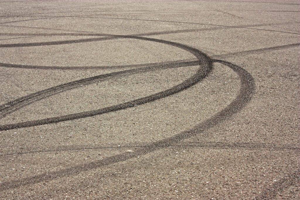 Various tire tracks on a racetrack after learning how to drive faster.